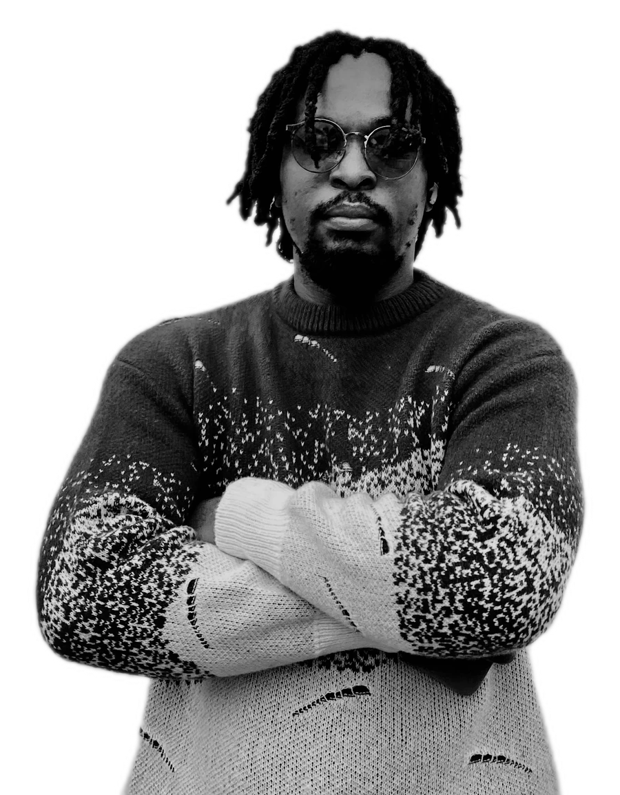 Victor Ezeama, arms folded, photographed in black and white.